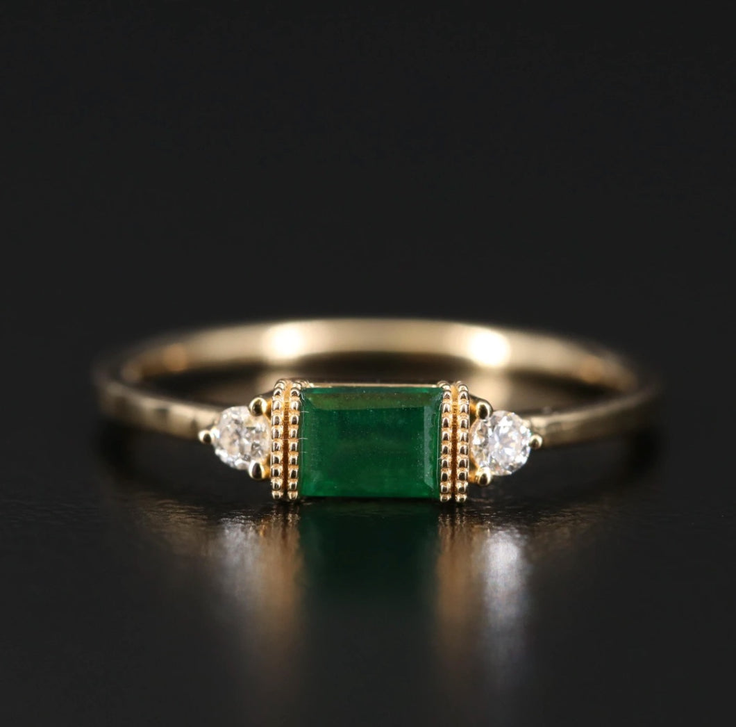 BAGUETTE EMERALD AND DIAMOND RING